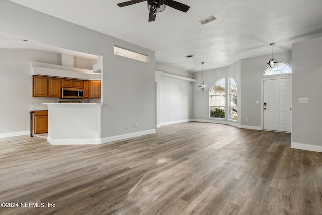 unfurnished living room featuring light hardwood / wood-style floors and ceiling fan