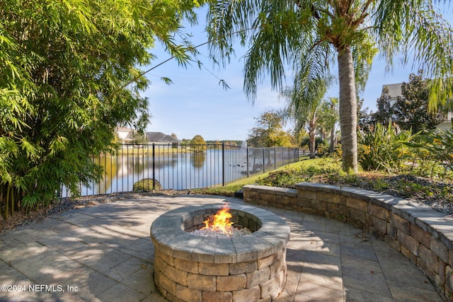 view of patio / terrace featuring a water view and an outdoor fire pit