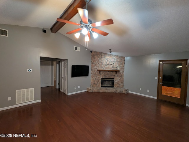 unfurnished living room featuring a fireplace, lofted ceiling with beams, dark hardwood / wood-style floors, and ceiling fan