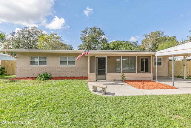 ranch-style house with a front lawn and a patio