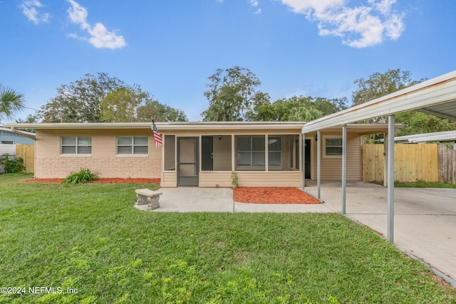 single story home with a sunroom, a carport, and a front lawn