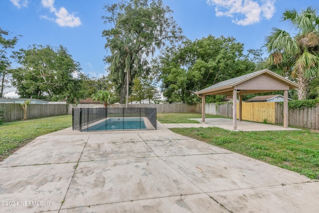 view of swimming pool featuring a patio and a yard