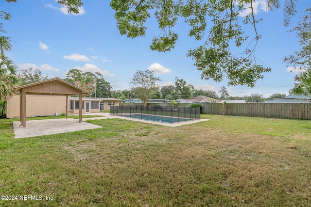 view of yard featuring a fenced in pool and a patio area