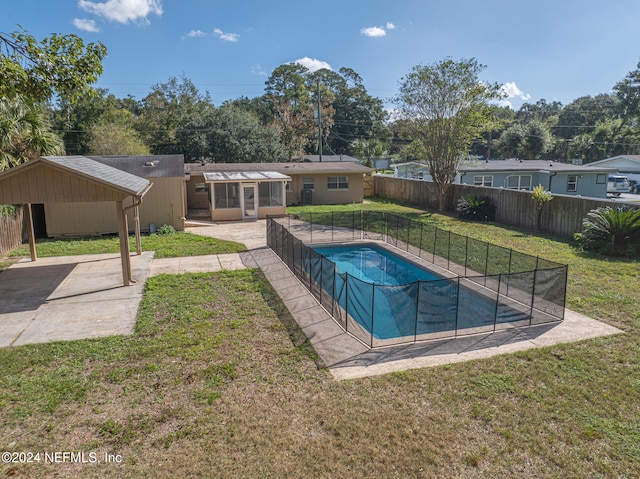 view of pool with a yard and a patio area