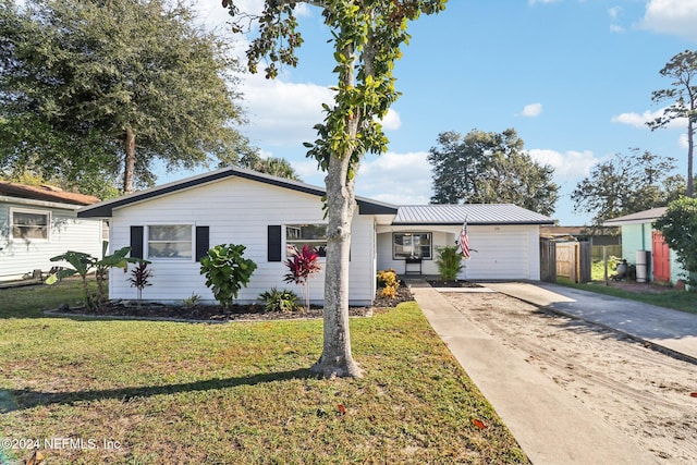 ranch-style home with a front lawn and a garage