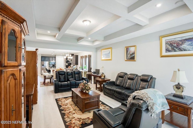 living room with coffered ceiling, beamed ceiling, light wood-type flooring, and a notable chandelier