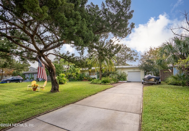 view of front facade with a garage and a front lawn