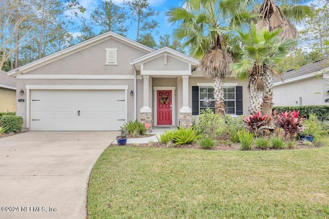 view of front of home featuring a front lawn and a garage