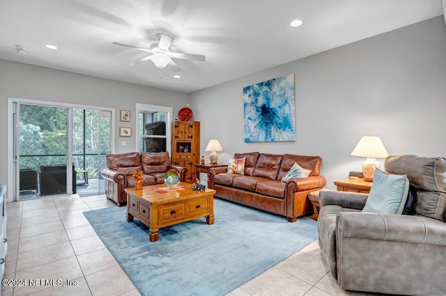 living room featuring ceiling fan and light tile patterned flooring