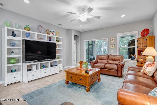 living room featuring ceiling fan and light tile patterned floors