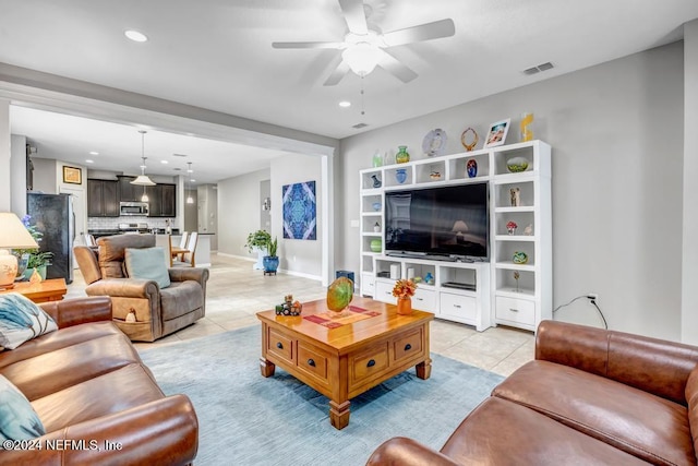 living room featuring ceiling fan and light tile patterned flooring