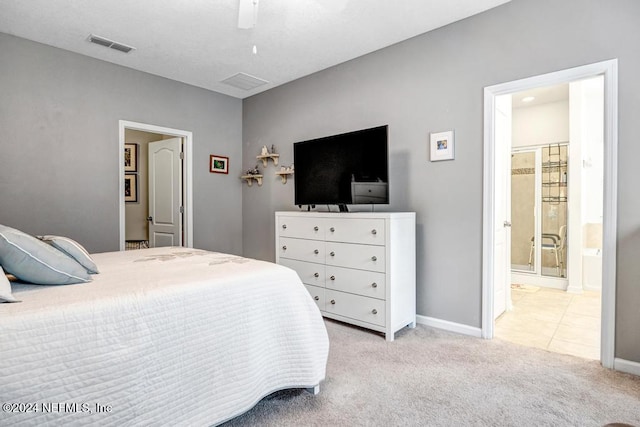 bedroom featuring ensuite bathroom, ceiling fan, and light carpet