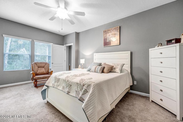 bedroom with ceiling fan and light colored carpet