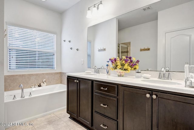 bathroom with tile patterned flooring, vanity, and plus walk in shower