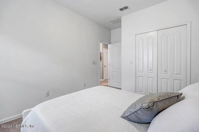 carpeted bedroom with a closet