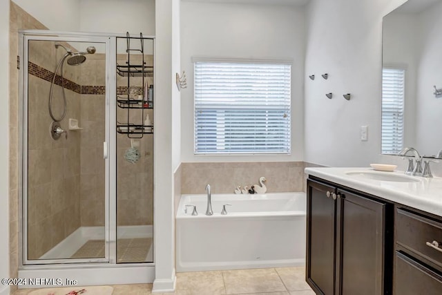 bathroom with shower with separate bathtub, vanity, tile patterned floors, and a healthy amount of sunlight