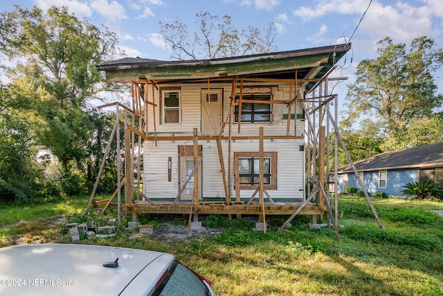 back of property featuring a porch