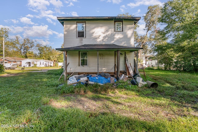 rear view of house with a yard