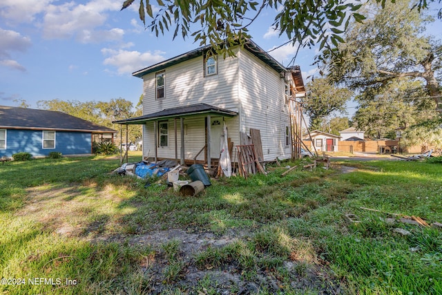 back of property with a yard