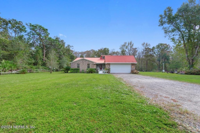 ranch-style house featuring a garage and a front lawn