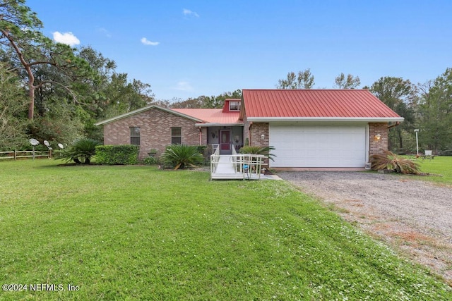 ranch-style home featuring a sunroom, a front lawn, and a garage