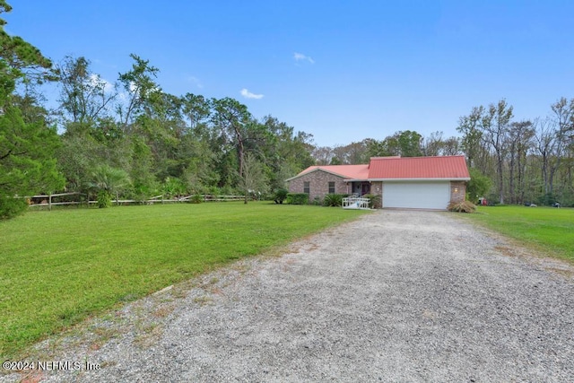 single story home with a front yard and a garage