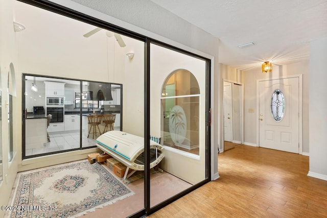 entryway with ceiling fan and light hardwood / wood-style flooring