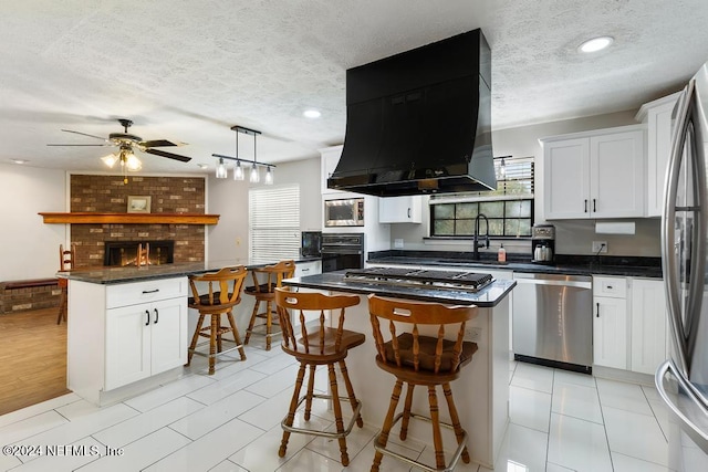 kitchen featuring white cabinets, stainless steel appliances, and a kitchen island