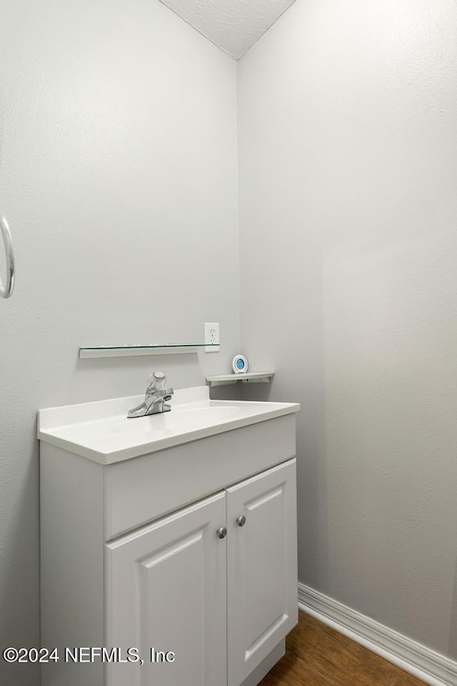 bathroom featuring hardwood / wood-style floors and vanity