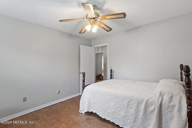 bedroom featuring ceiling fan and dark wood-type flooring