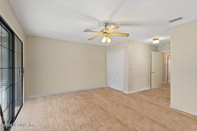 spare room featuring ceiling fan and light wood-type flooring