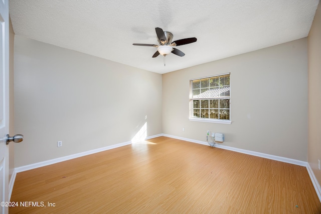 spare room with wood-type flooring, a textured ceiling, and ceiling fan