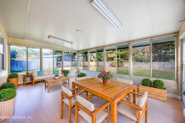 sunroom with plenty of natural light and lofted ceiling