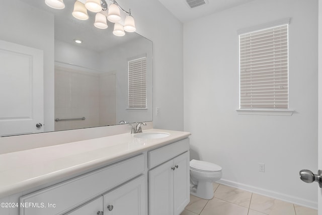 bathroom with tile patterned flooring, vanity, and toilet