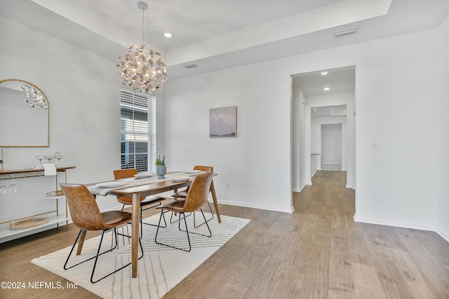 dining area featuring a chandelier and light hardwood / wood-style floors