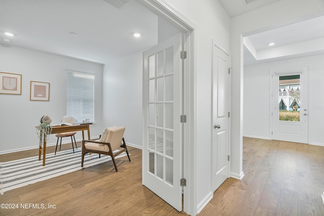 corridor with light hardwood / wood-style floors