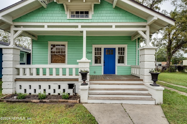 craftsman inspired home with covered porch and a front yard