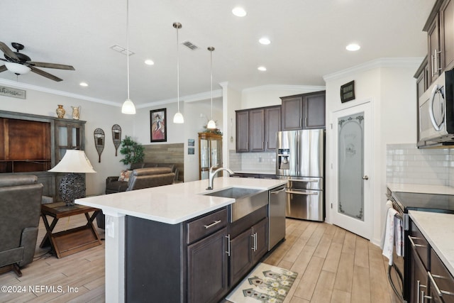 kitchen with backsplash, ceiling fan, hanging light fixtures, and stainless steel appliances