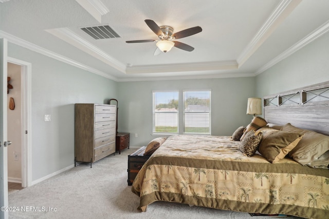 bedroom with ceiling fan, crown molding, and a tray ceiling