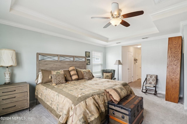 bedroom with a raised ceiling, ceiling fan, crown molding, and light colored carpet