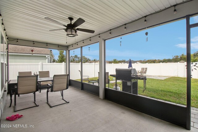 sunroom with ceiling fan and plenty of natural light