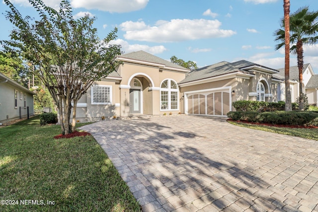 view of front facade with a garage and a front lawn