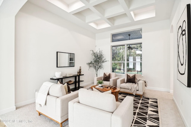 living room featuring beamed ceiling, light colored carpet, and coffered ceiling