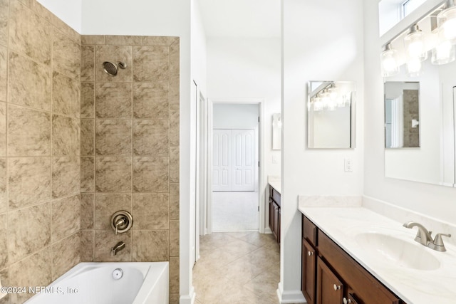 bathroom featuring tile patterned floors, vanity, and tiled shower / bath