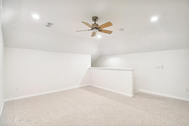 additional living space with light carpet, ceiling fan, and lofted ceiling