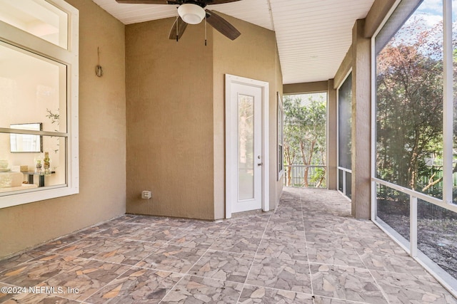 unfurnished sunroom featuring vaulted ceiling, ceiling fan, and wood ceiling