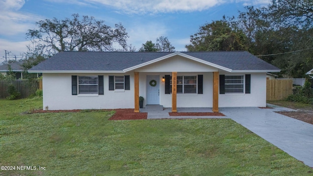 ranch-style house with covered porch and a front yard