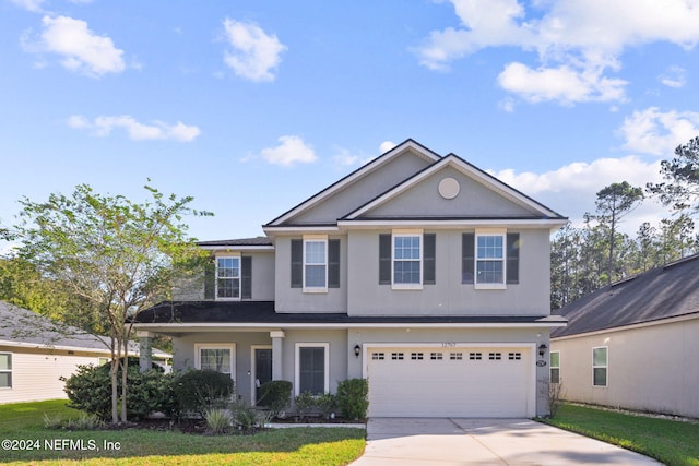 view of front property with a garage and a front yard