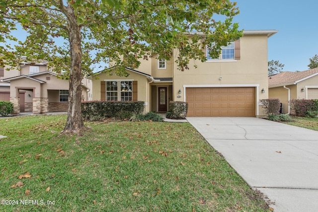 view of front of home featuring a garage and a front lawn