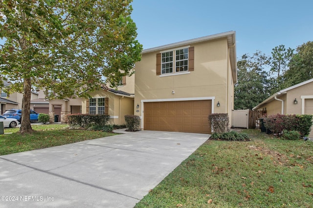 view of front of property with a front yard and a garage